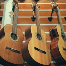 Row of classical acoustic guitars in musical store.