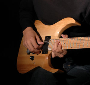 Close-up: Hands Of A Musician Playing Electric Guitar